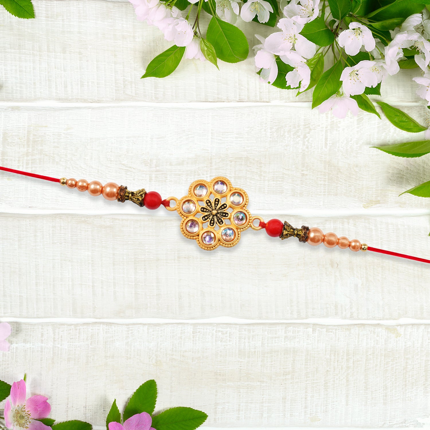 Gold-toned Floral Rakhi With Pink Stones Gold-toned Floral Rakhi With Pink Stones